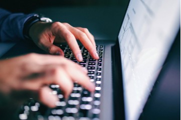 Professional using a laptop for public-sector technology management